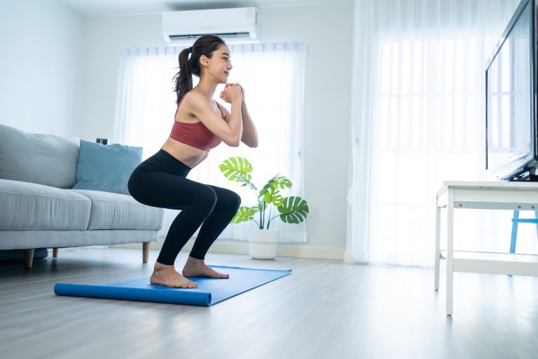 Asian Beautiful young woman stay home, doing aerobic exercise at home for health in house.