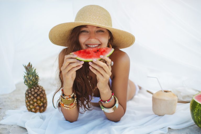 Woman on the Tropical Beach Eating Watermelon