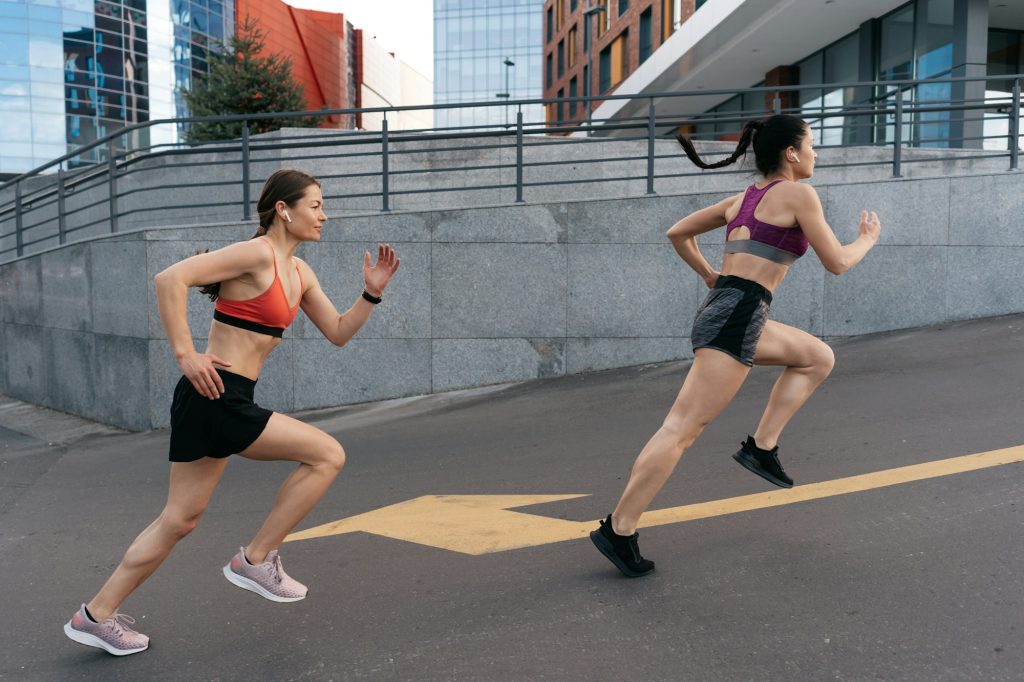 Women sprinting in the morning outdoors.